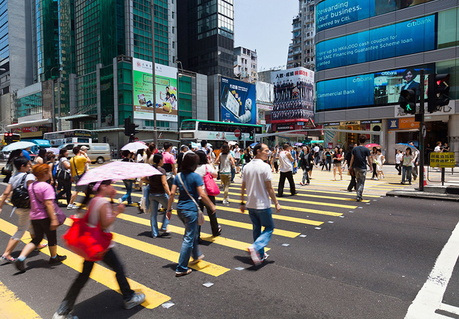 39469979 - hong kong, china - august 13, 2011: pedestrians crossing a busy crosswalk in mongkok, hong kong, with advestising boards and financial buildings in the background.